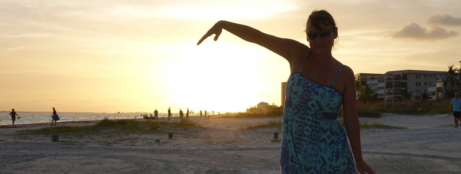 Woman watching the sunset in Florida, thinking about emigrating to USA